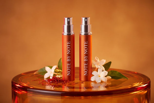 Two Note by Note travel sprays with saffron and jasmine on amber glass