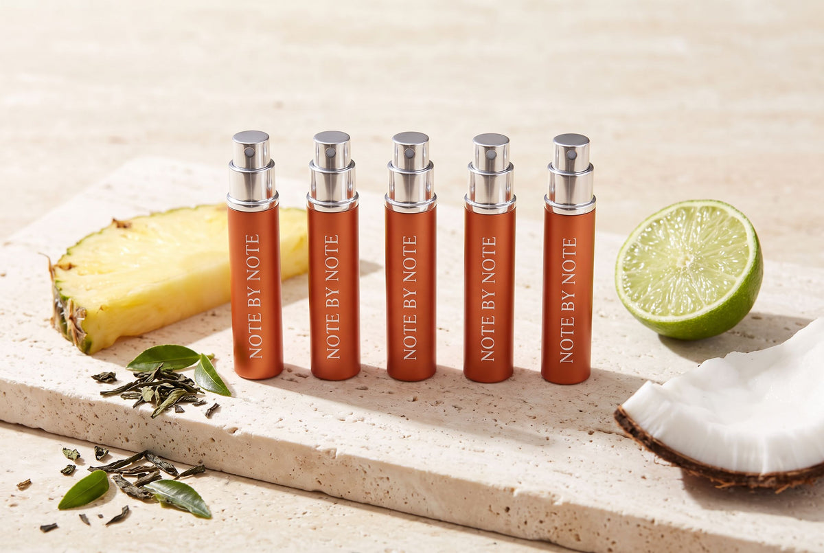 Five Note by Note travel sprays with pineapple, lime, coconut and green tea on travertine